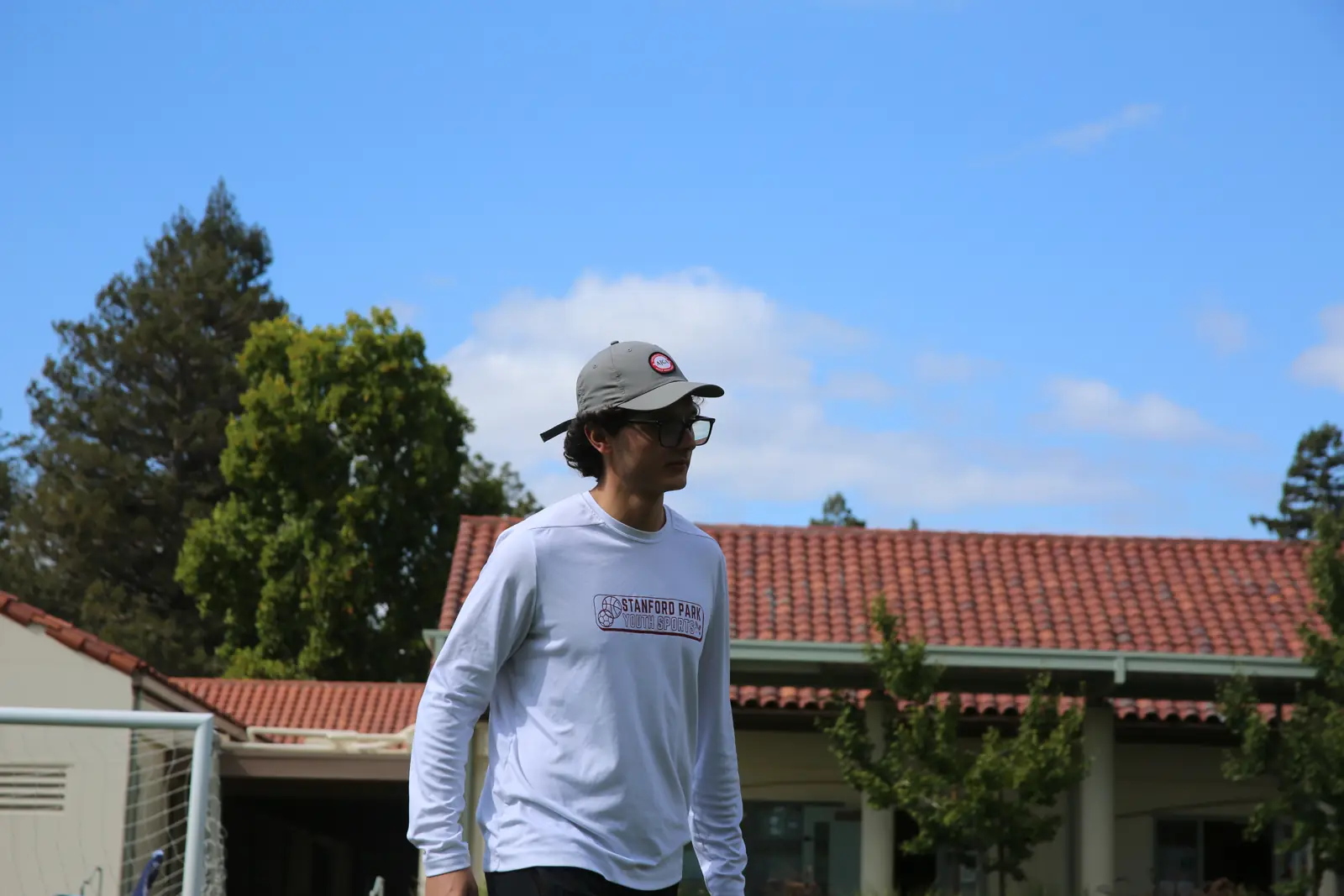 Stanford Park Sports coach on a school field under a blue sky