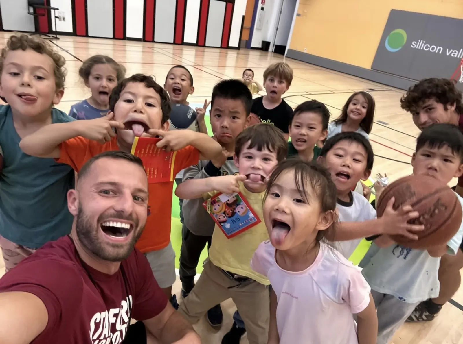Coach taking a selfie with laughing students